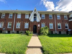Louisville apartment for rent - A brick building with a black door and windows.