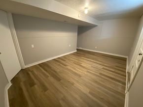 Louisville apartment for rent - A room with wooden flooring and white walls.