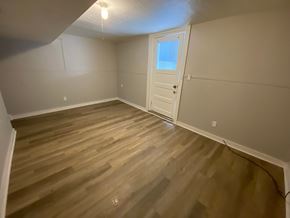 Louisville apartment for rent - A room with wooden flooring and a white door.