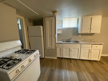 Louisville apartment for rent - A kitchen with a white stove and cabinets.
