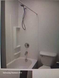 Baltimore house for rent - A white bathroom with a toilet and a shower.