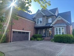 Hendersonville house for rent - A house with a brick facade and a grey garage door.