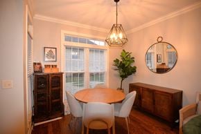 Hendersonville house for rent - A dining room with a wooden table and chairs.