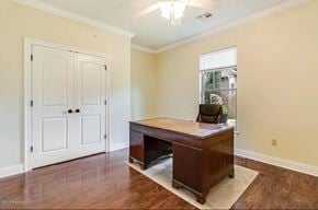 Lafayette house for rent - A room with a wooden desk and a white door.