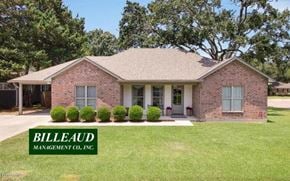 Lafayette house for rent - A brick house with the name Billeaud Management Co. Inc. on the lawn.