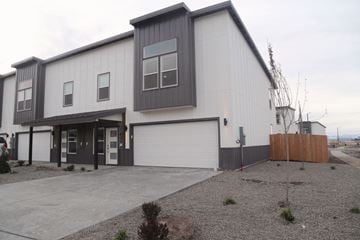 Belgrade apartment for rent - A modern two-story building with a garage door and a gravel driveway.