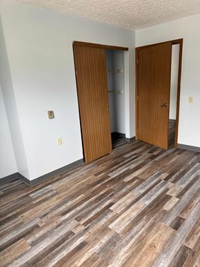 New  Waterford apartment for rent - A room with a wooden floor and two wooden doors.