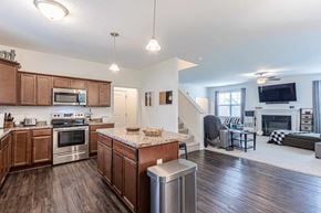 Jacksonville house for rent - A modern kitchen with wooden cabinets and a marble island.