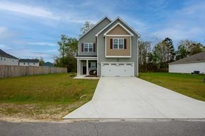Jacksonville house for rent - A house with a grey roof and a white garage door.