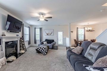 Jacksonville house for rent - A living room with a grey couch and a fireplace.