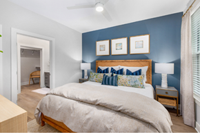 Charleston apartment for rent - A bedroom with a large bed and a ceiling fan.