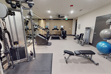 Charleston apartment for rent - A gym with a variety of equipment including a treadmill, weights, and a bench press.
