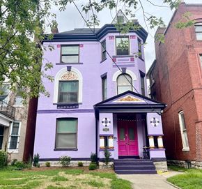 Louisville apartment for rent - A purple house with a red door and a small porch.