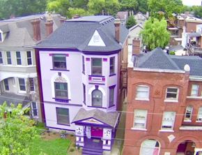 Louisville apartment for rent - A purple house with a black roof is in the foreground.