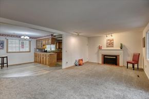 Spokane house for rent - A living room with a fireplace and a chair.