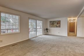Spokane house for rent - A spacious room with a carpeted floor and a large window.