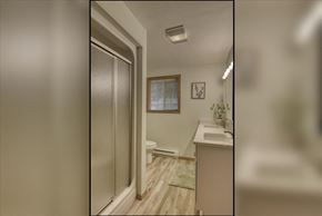 Spokane house for rent - A bathroom with a toilet, sink, and a window.