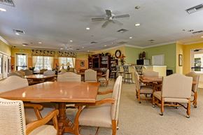Bradenton house for rent - A dining room with a wooden table and chairs.