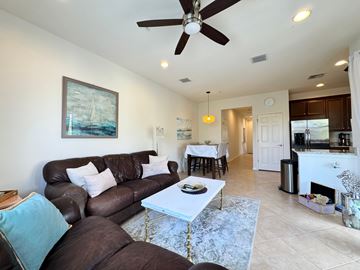 Bradenton house for rent - A living room with a brown couch and a white coffee table.