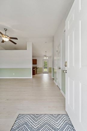 Richlands house for rent - A long hallway with a rug on the floor and a ceiling fan.