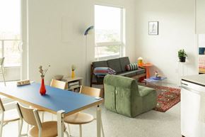 Victoria apartment for rent - A dining table with a blue top and four chairs around it.