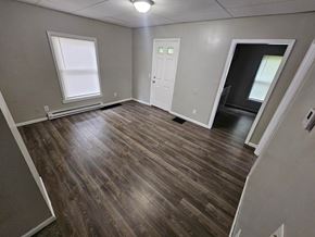 Lima house for rent - A room with wooden flooring and a white door.