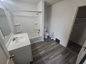 Lima house for rent - A bathroom with a white sink, toilet, and bathtub.
