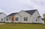 Goldsboro apartment for rent - A white house with a black roof and a grey lawn.
