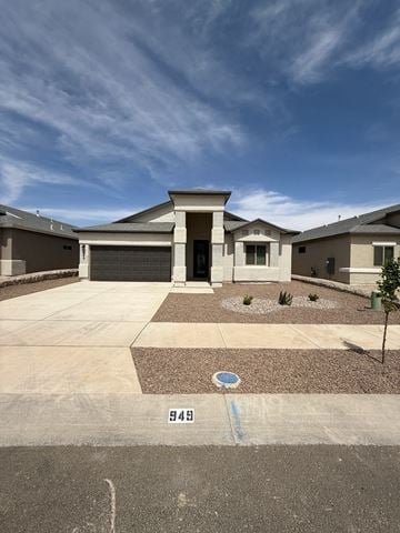 El Paso house for rent - A house with a driveway and a small tree in front.