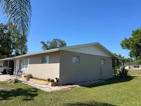Fort Myers apartment for rent - A house with a beige exterior and a white roof.