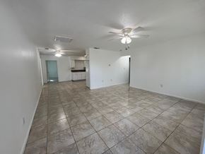 Fort Myers apartment for rent - A spacious room with a ceiling fan and tile flooring.