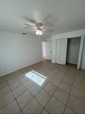 Fort Myers apartment for rent - A room with a ceiling fan and tile flooring.