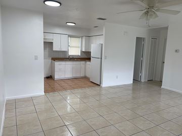Fort Myers apartment for rent - A kitchen with white cabinets and a fan on the ceiling.