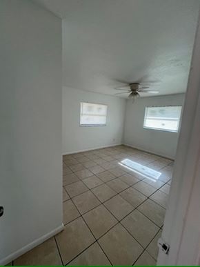 Fort Myers apartment for rent - A room with a tiled floor and a ceiling fan.