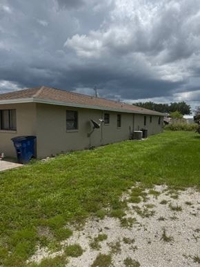 Fort Myers apartment for rent - A house with a blue trash bin in front of it.