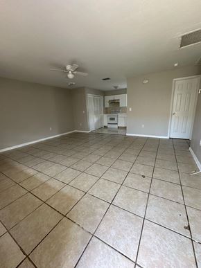 Fort Myers apartment for rent - A spacious room with tile flooring and a ceiling fan.