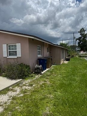 Fort Myers apartment for rent - A house with a brown roof and a blue trash can.