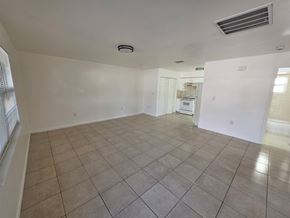 Fort Myers apartment for rent - A spacious room with tiled flooring and a ceiling fan.
