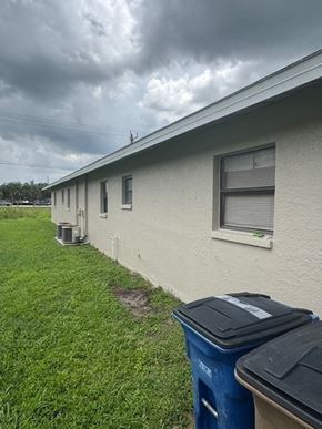 Fort Myers apartment for rent - A row of houses with a blue trash can in front of the first house.
