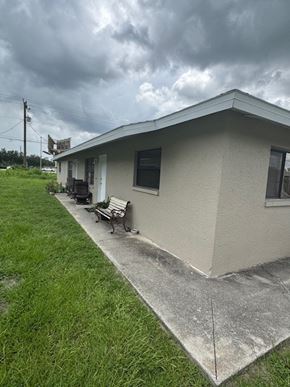 Fort Myers apartment for rent - A house with a grey roof and a concrete walkway leading to the front door.