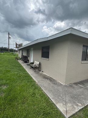 Fort Myers apartment for rent - A small house with a grey roof and a concrete walkway in front.