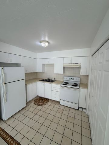 Fort Myers apartment for rent - A kitchen with white appliances and white cabinets.