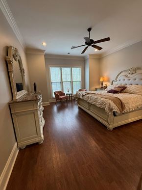 Lafayette house for rent - A bedroom with a large bed and a dresser with a mirror.