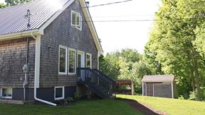 Scotsburn house for rent - A house with a grey exterior and a white trim.