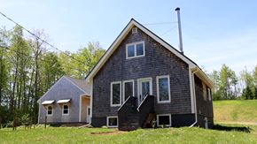 Scotsburn house for rent - A house with a grey roof and a black staircase.