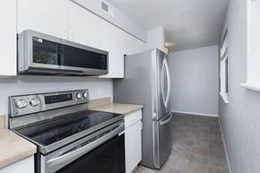 Denver apartment for rent - A kitchen with a stainless steel refrigerator, oven, and microwave.