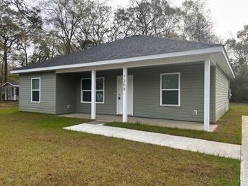 Mobile house for rent - A small house with a grey roof and white trim.