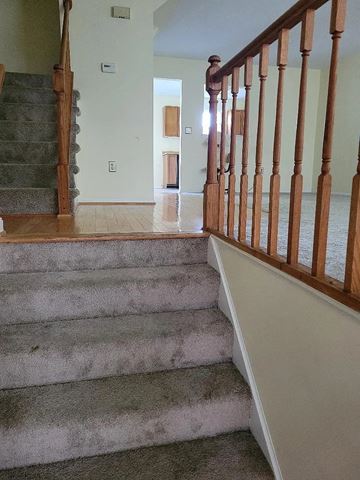 Lanham house for rent - A staircase with a carpeted runner and wooden banister.