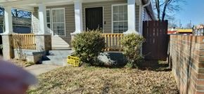 Atlanta house for rent - A house with a brown fence and a small garden in front.