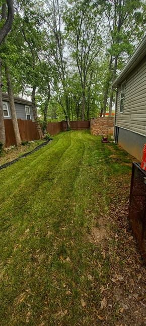 Atlanta house for rent - A backyard with a green lawn and trees.